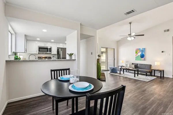 a view of a dining room with furniture and wooden floor