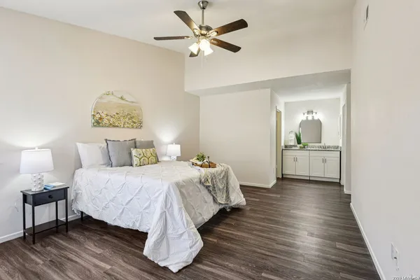a bedroom with a bed and wooden floor