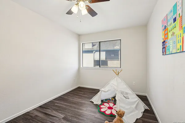a bedroom with furniture and a wooden floor