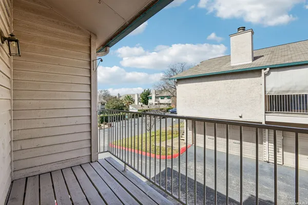 a view of a balcony with wooden floor