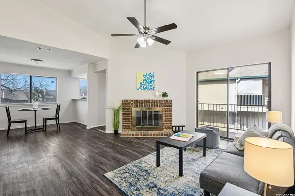 a living room with furniture a table and a large window