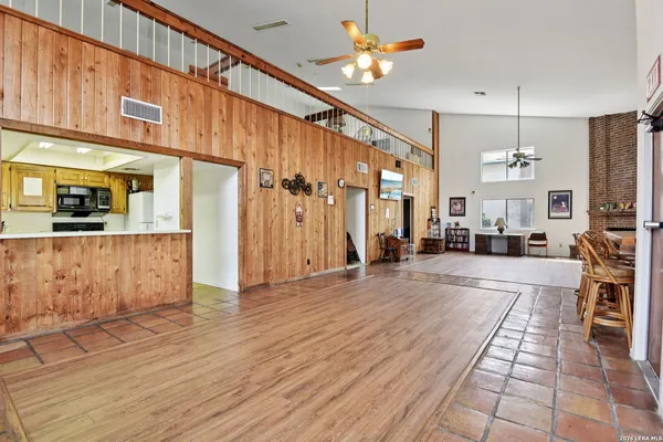 a view of a living room and kitchen with stainless steel appliances