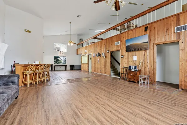 a view of a hallway with wooden floor and furniture
