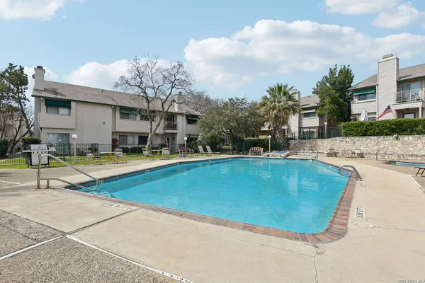 a view of a swimming pool with a lounge chairs