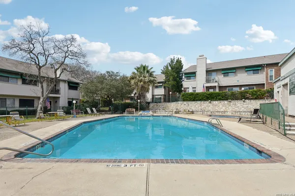 a view of a swimming pool and lounge chairs