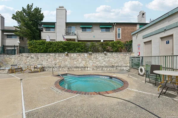 a view of a swimming pool with chairs