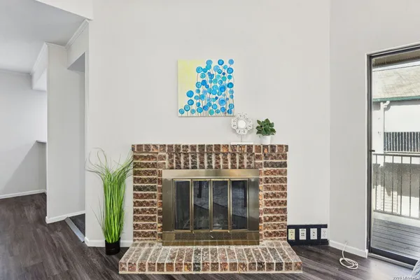 a living room with a rug and a fireplace