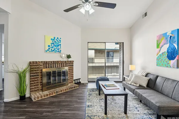 a living room with furniture a fireplace and a table