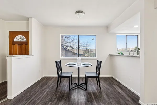 a dining room with furniture and wooden floor
