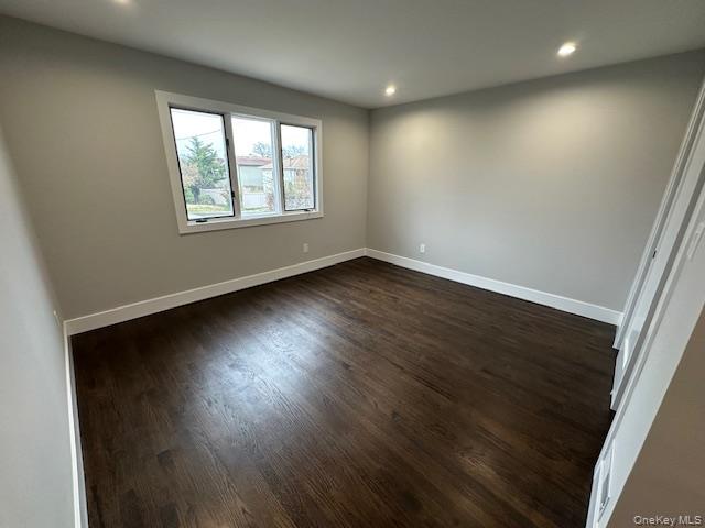 5 Linwood Road North, Unit 1 Port Washington, NY 11050 - Photo 6 of 12 Bedroom with dark wood finished floors and recessed lighting