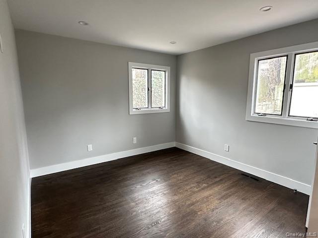 5 Linwood Road North, Unit 1 Port Washington, NY 11050 - Photo 8 of 12 Bedroom with dark wood-style floors and recessed lighting
