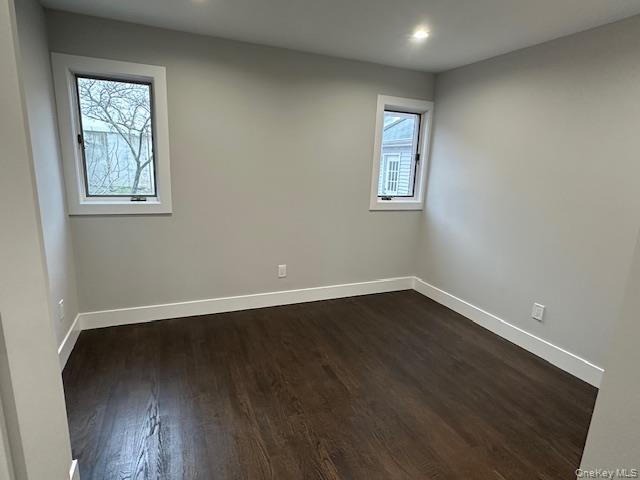 5 Linwood Road North, Unit 1 Port Washington, NY 11050 - Photo 10 of 12 Bedroom featuring dark wood-type flooring and recessed lighting