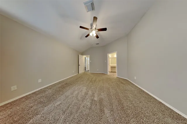 a view of empty room with ceiling fan