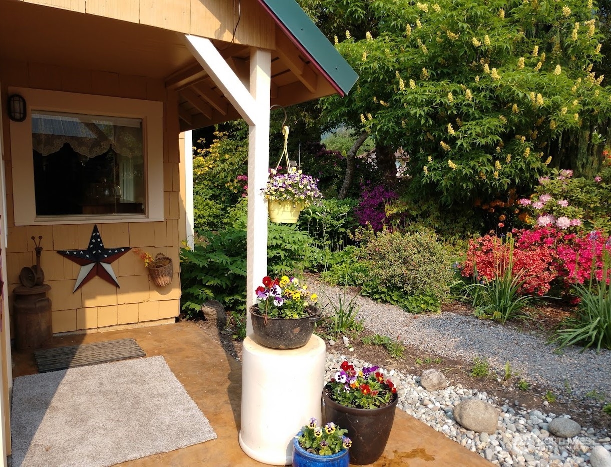 a view of a patio with table and chairs potted plants