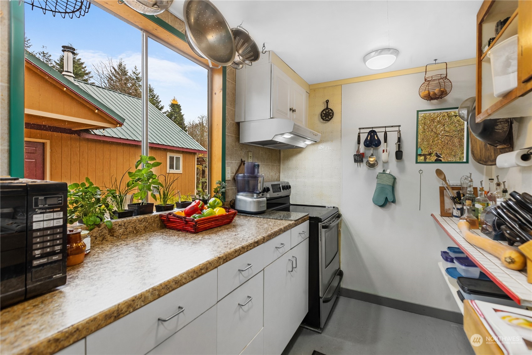 36922 Swede Heaven Road Arlington, WA 98223 - Photo 18 of 40 a kitchen with stainless steel appliances granite countertop a sink a stove and cabinets