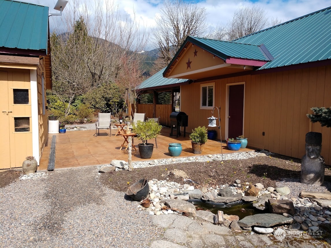 36922 Swede Heaven Road Arlington, WA 98223 - Photo 2 of 40 a patio with table and chairs with potted plants