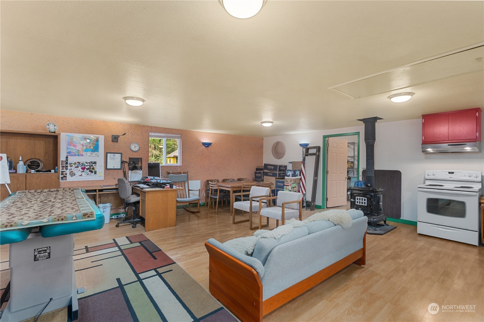 36922 Swede Heaven Road Arlington, WA 98223 - Photo 27 of 40 a living room with furniture a flat screen tv and kitchen view
