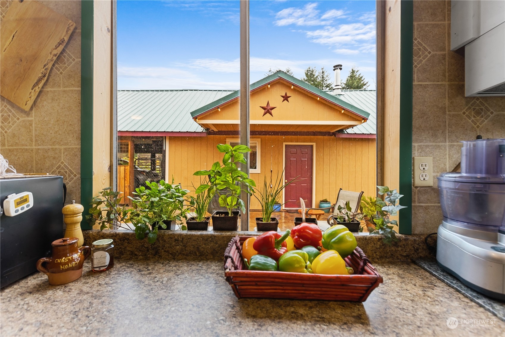 36922 Swede Heaven Road Arlington, WA 98223 - Photo 3 of 40 a front view of a house with outdoor seating and a potted plant