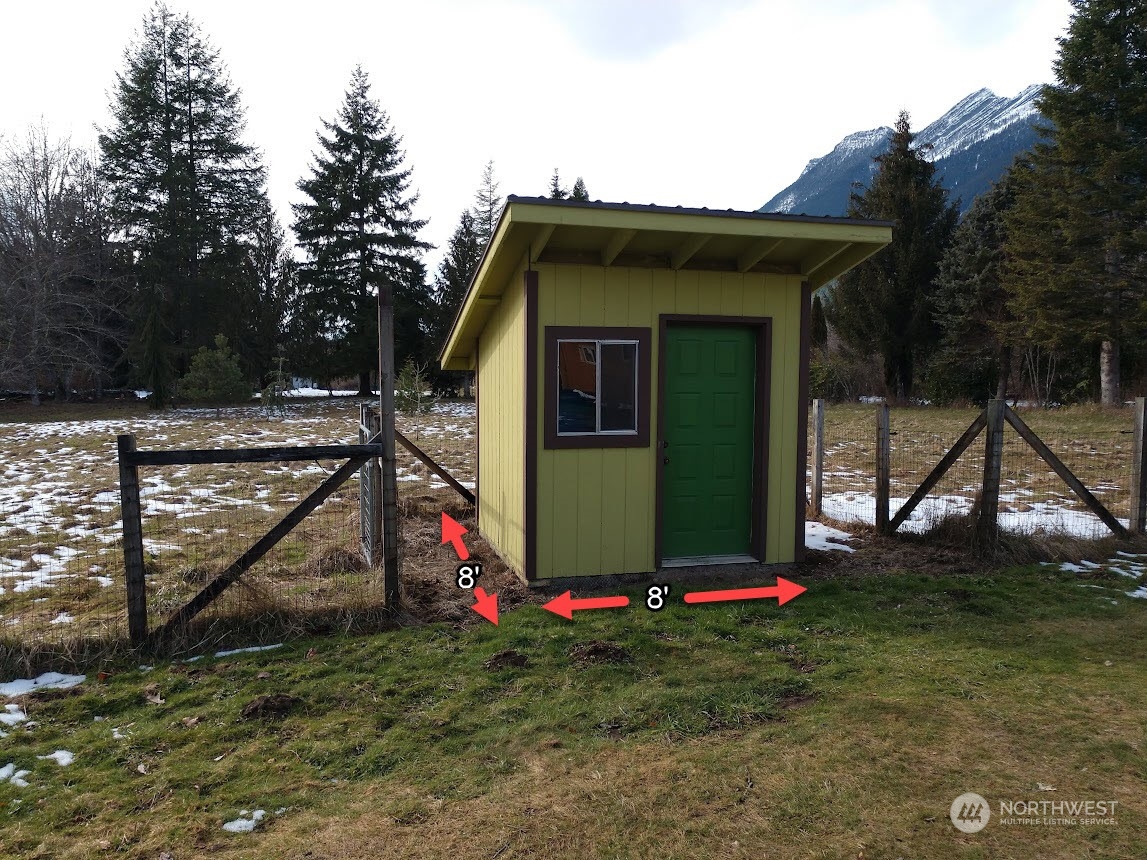 36922 Swede Heaven Road Arlington, WA 98223 - Photo 34 of 40 a view of a small house with a small yard and large trees