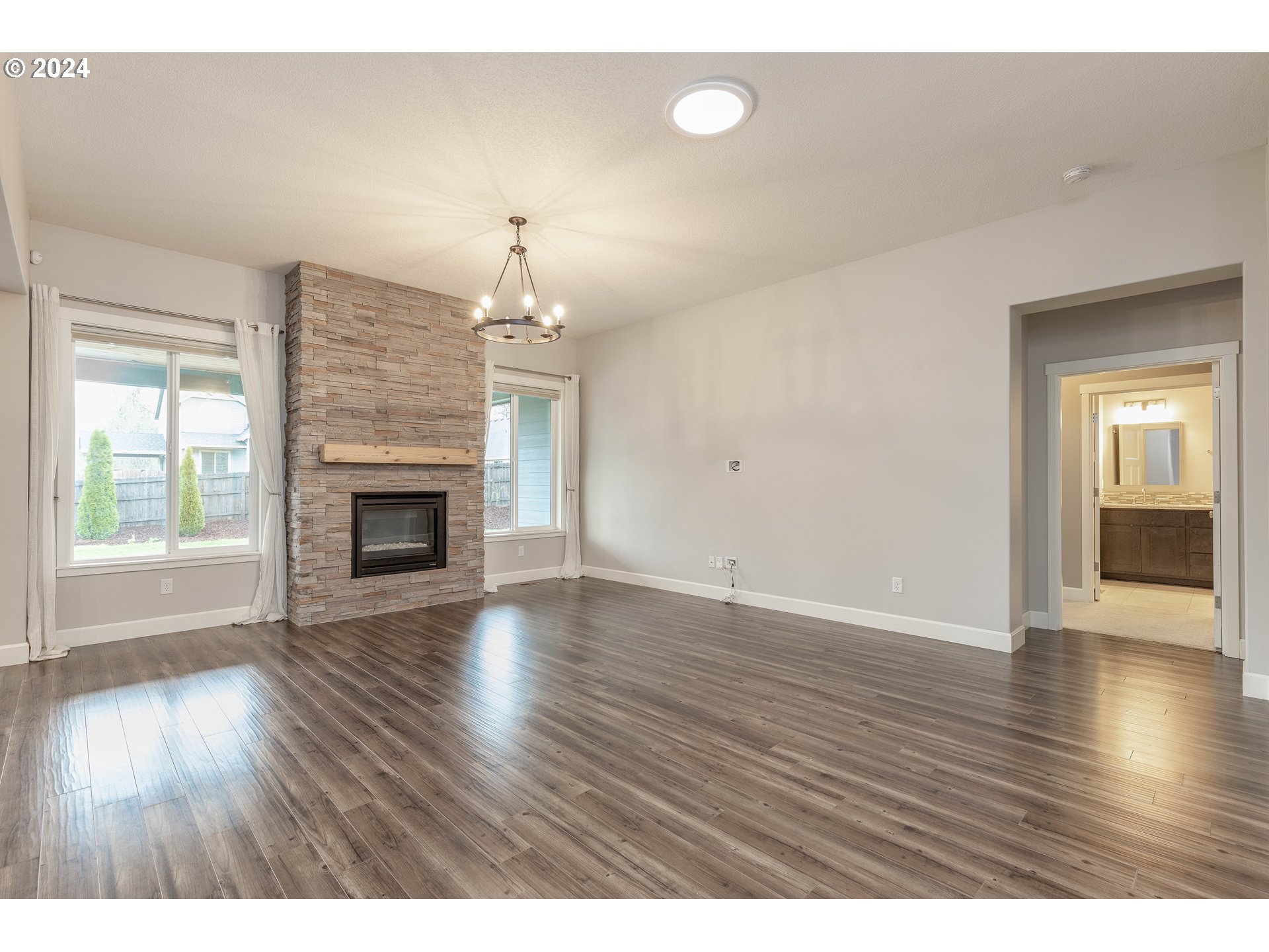 2714 Northeast 167th Circle Ridgefield, WA 98642 - Photo 14 of 35 a view of an empty room with wooden floor fireplace and a window