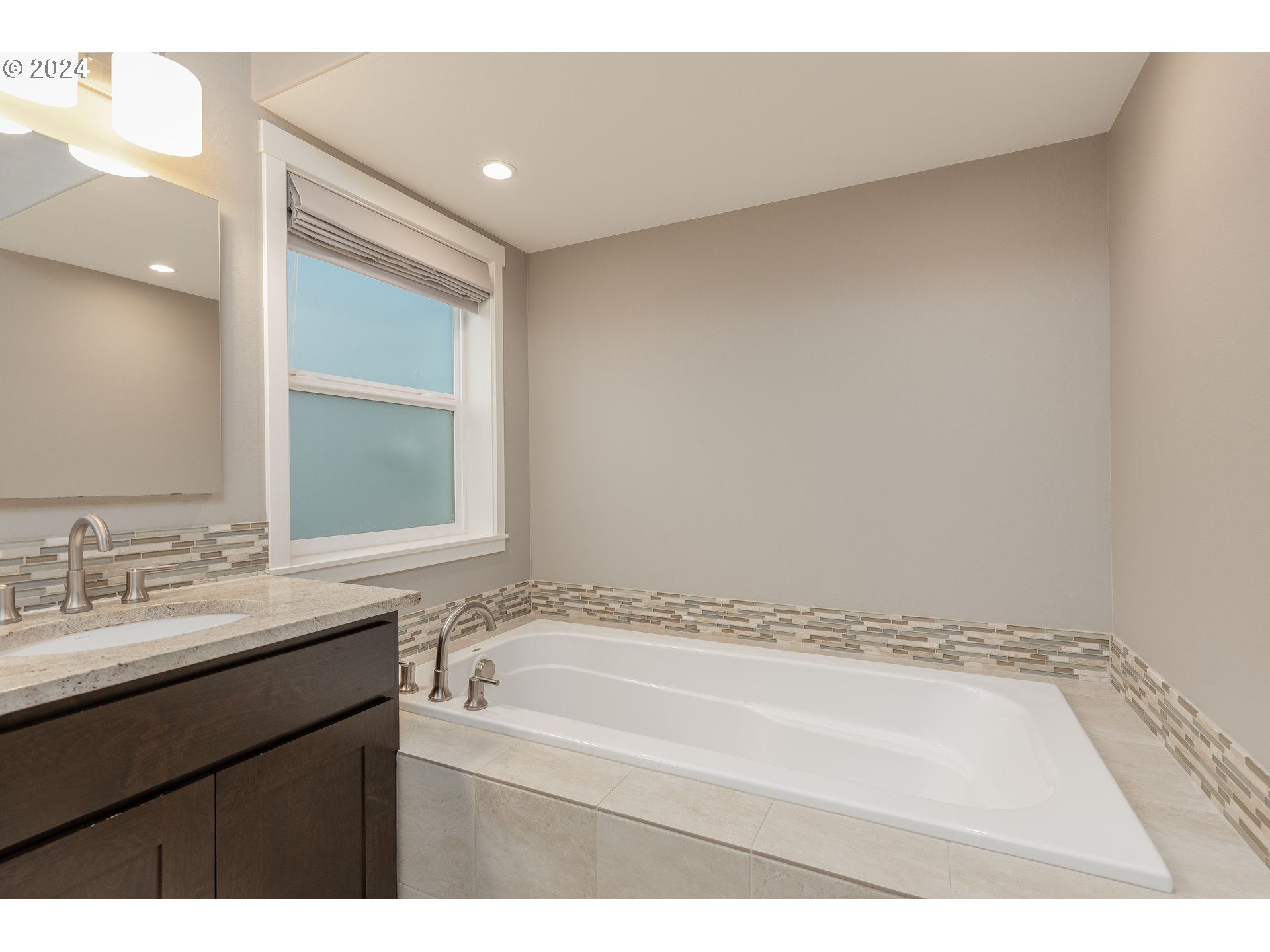 2714 Northeast 167th Circle Ridgefield, WA 98642 - Photo 18 of 35 a bathroom with a granite countertop sink a mirror and a bathtub