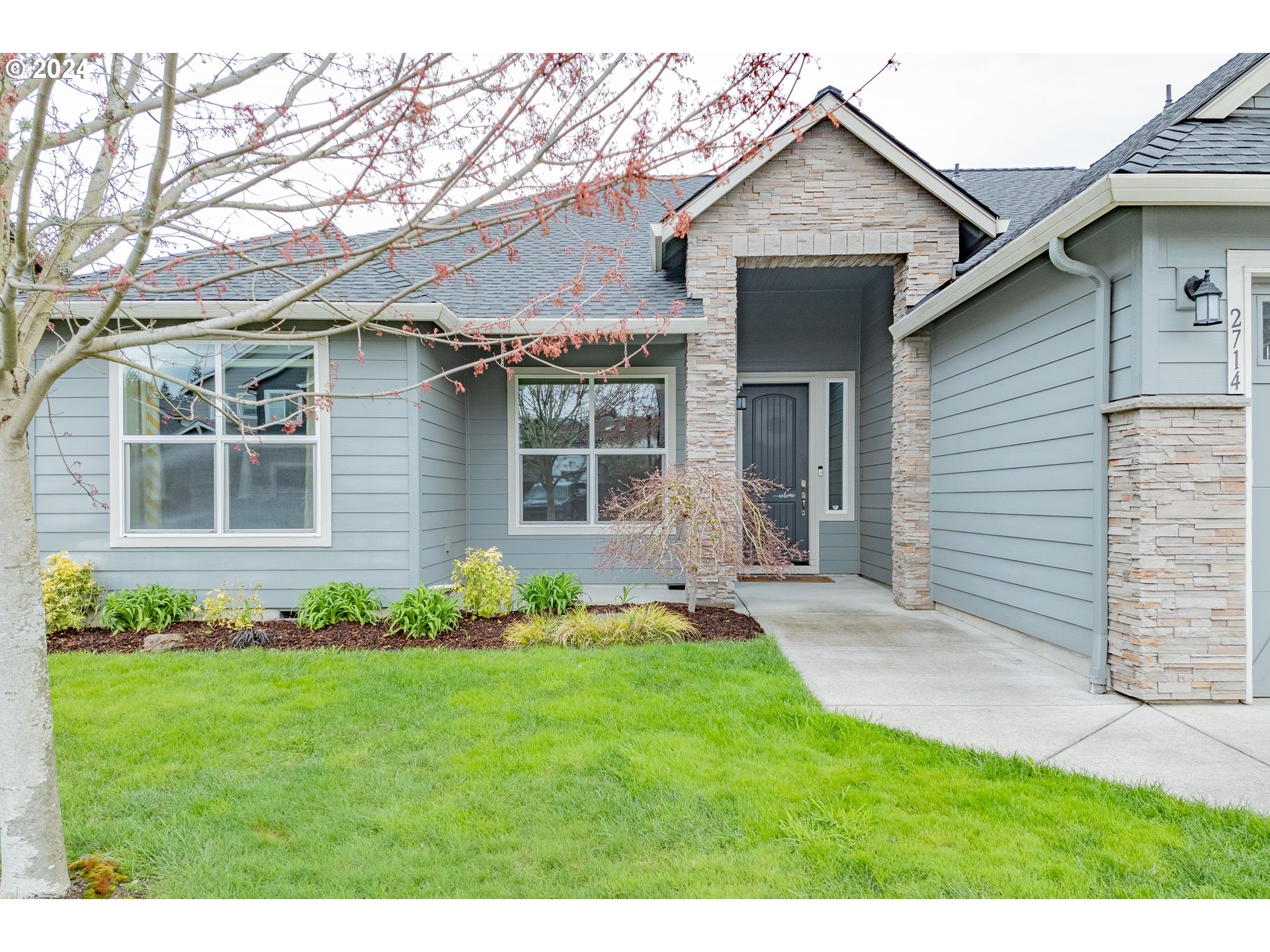 2714 Northeast 167th Circle Ridgefield, WA 98642 - Photo 2 of 35 a front view of a house with a garden