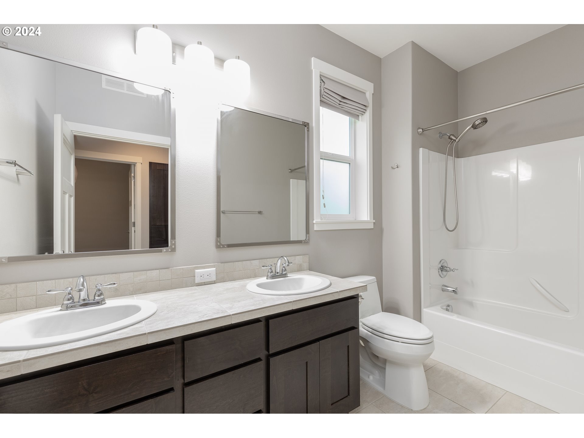 2714 Northeast 167th Circle Ridgefield, WA 98642 - Photo 23 of 35 a bathroom with a sink double vanity granite tub and a mirror