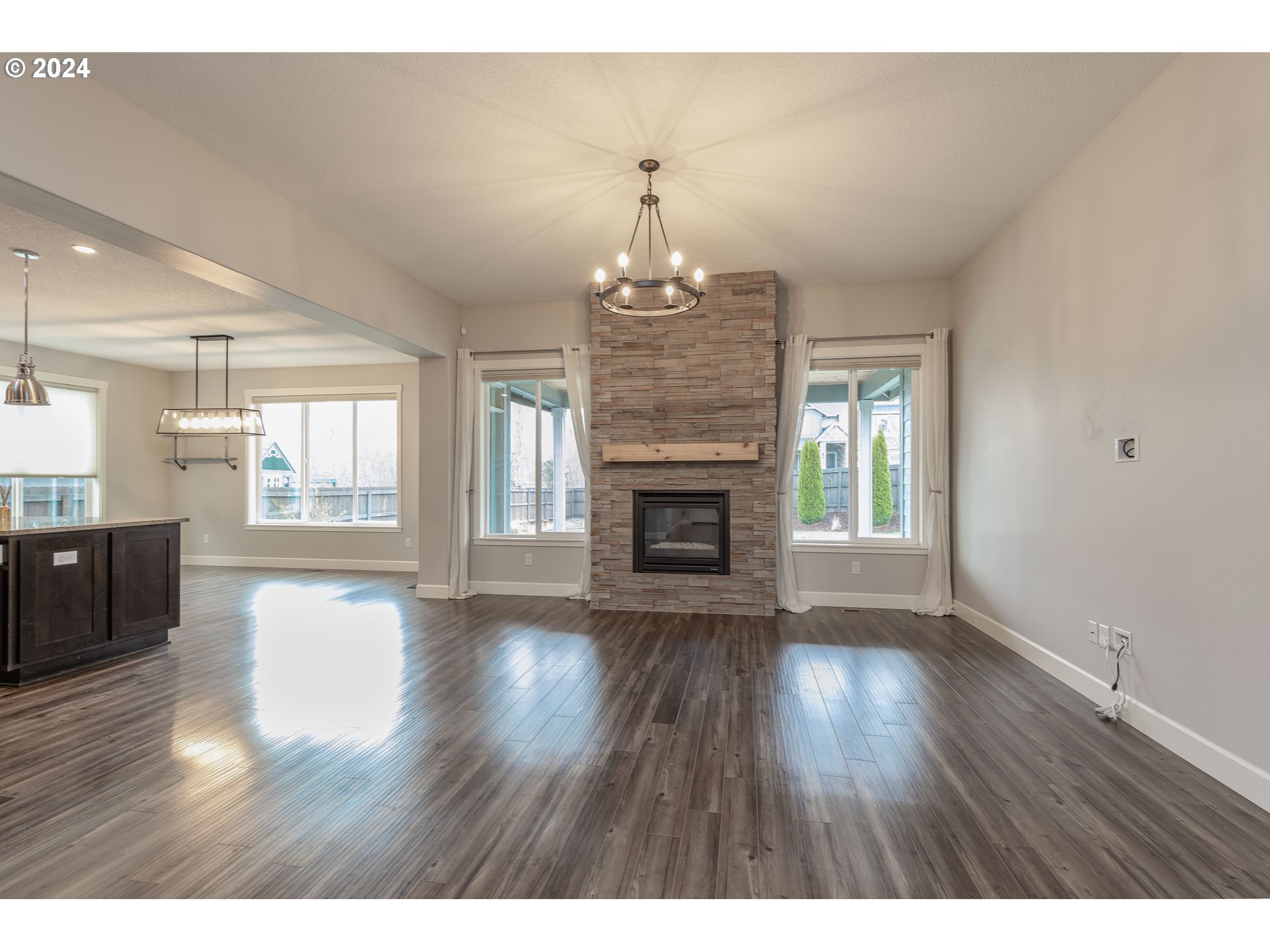 2714 Northeast 167th Circle Ridgefield, WA 98642 - Photo 3 of 35 a view of an empty room with wooden floor and a window