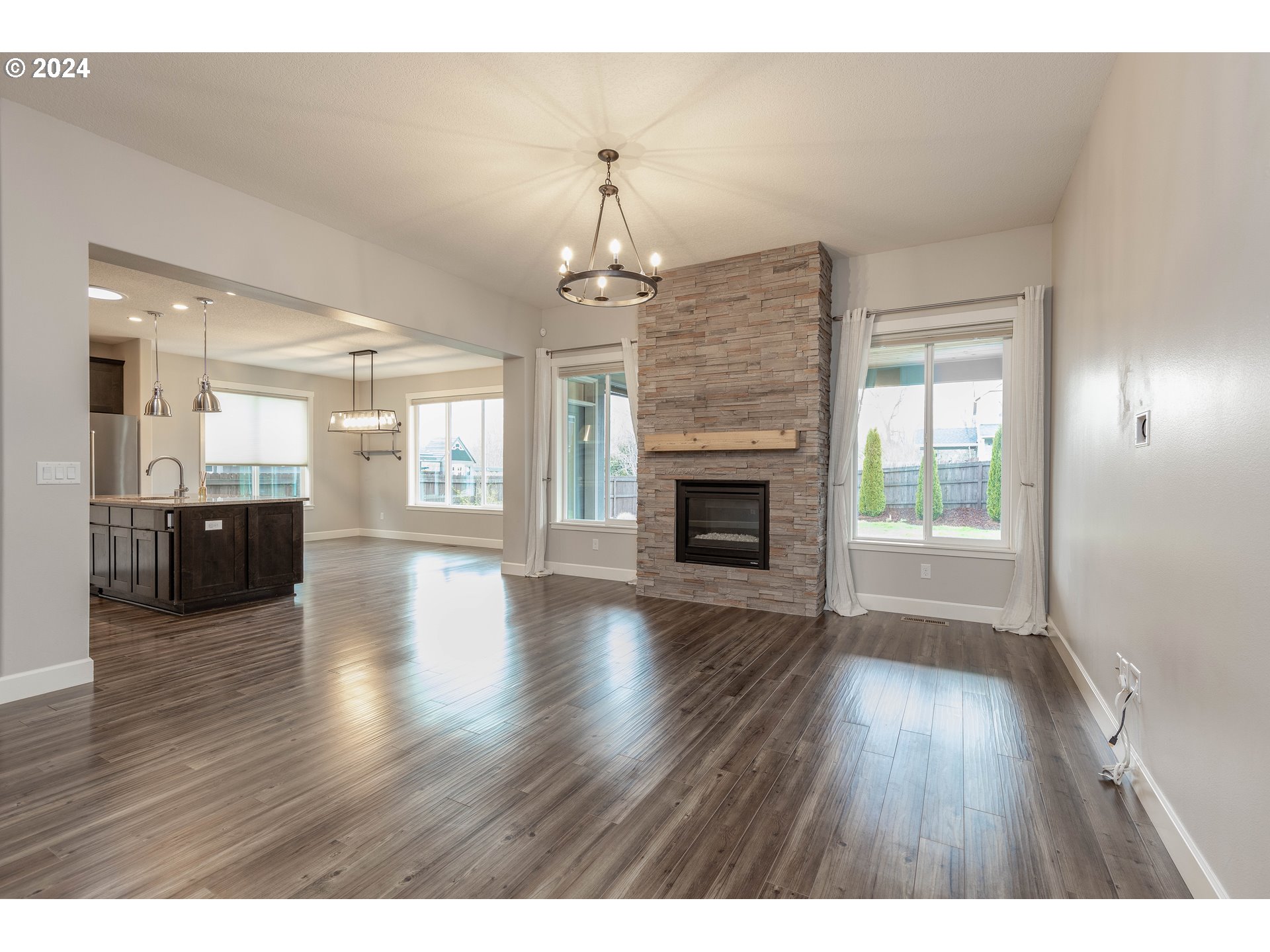 2714 Northeast 167th Circle Ridgefield, WA 98642 - Photo 4 of 35 a view of an empty room with wooden floor and a fireplace