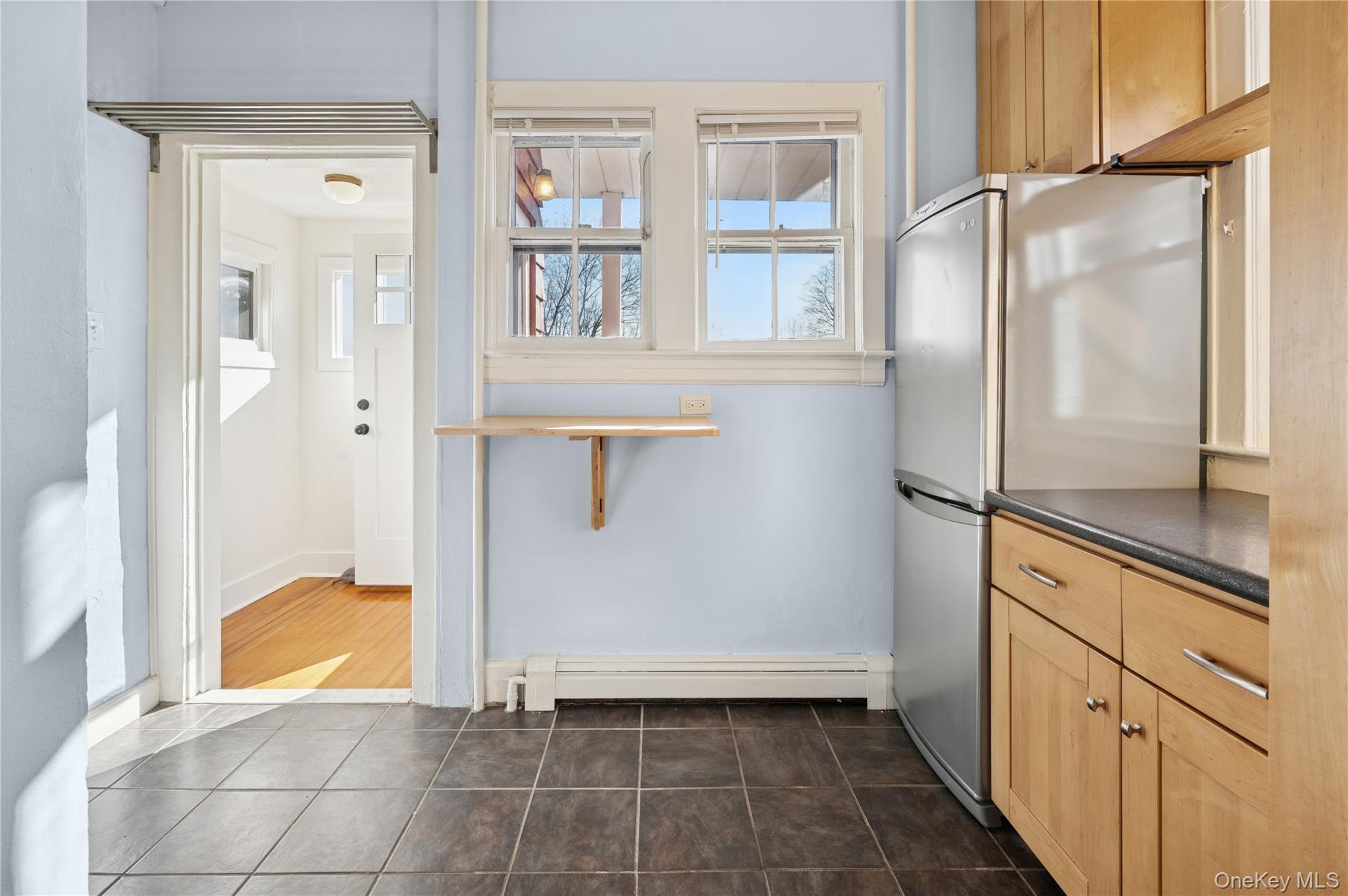 53 Allen Street, Unit 2 Dobbs Ferry, NY 10522 - Photo 14 of 28 Kitchen with freestanding refrigerator, dark countertops, light brown cabinets, and healthy amount of natural light