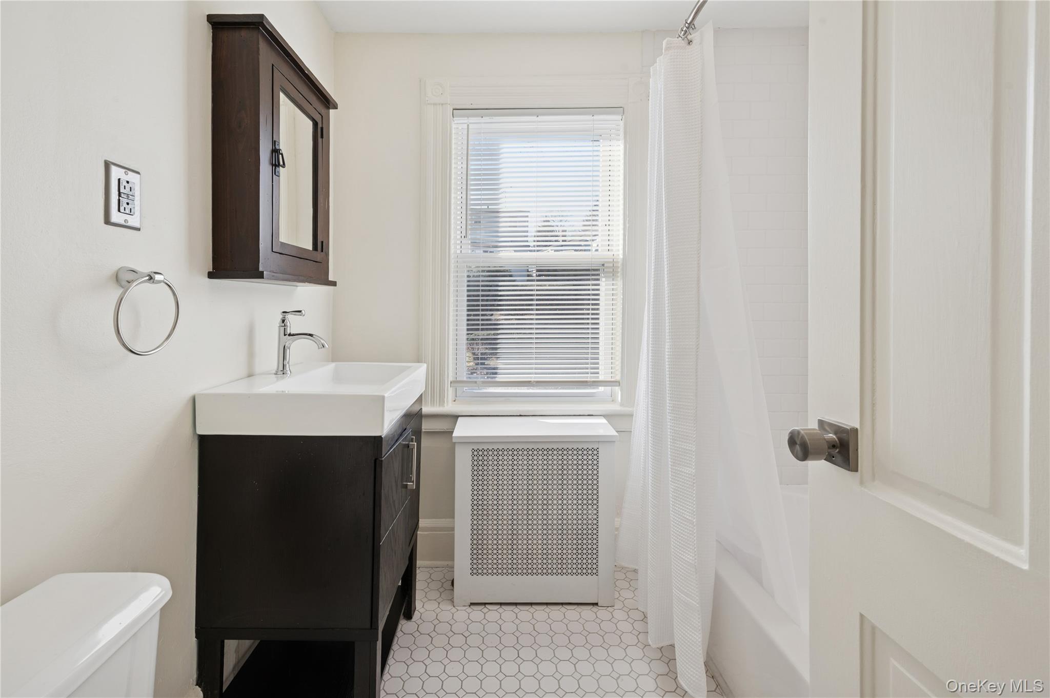 53 Allen Street, Unit 2 Dobbs Ferry, NY 10522 - Photo 16 of 28 Full bathroom with radiator heating unit, vanity, and shower / bathtub combination with curtain