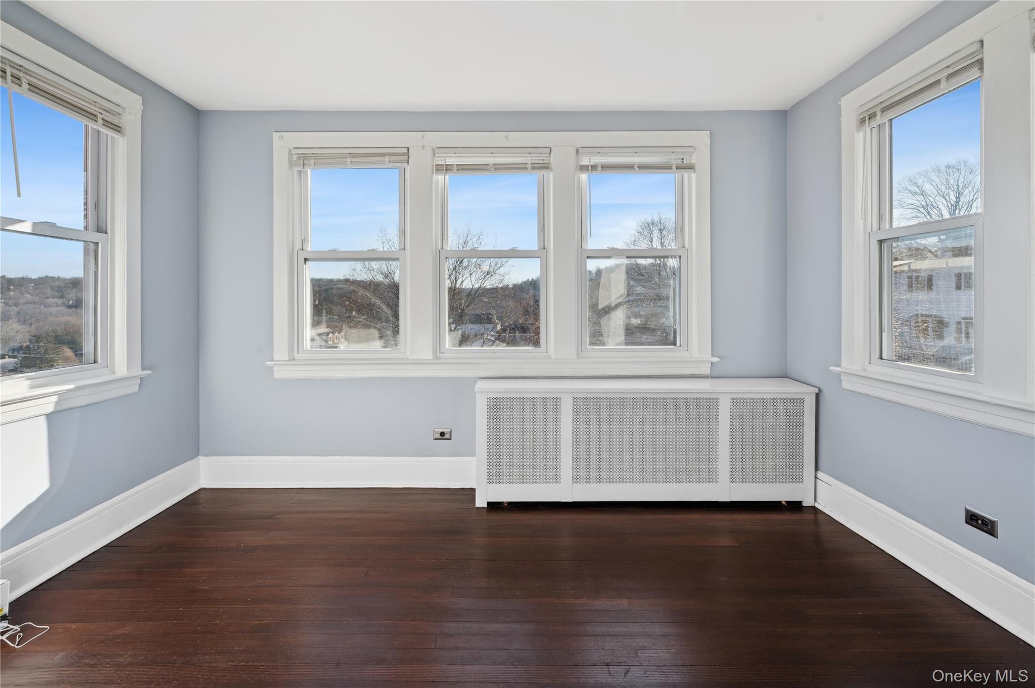 53 Allen Street, Unit 2 Dobbs Ferry, NY 10522 - Photo 22 of 28 Spare room with radiator and dark wood-type flooring