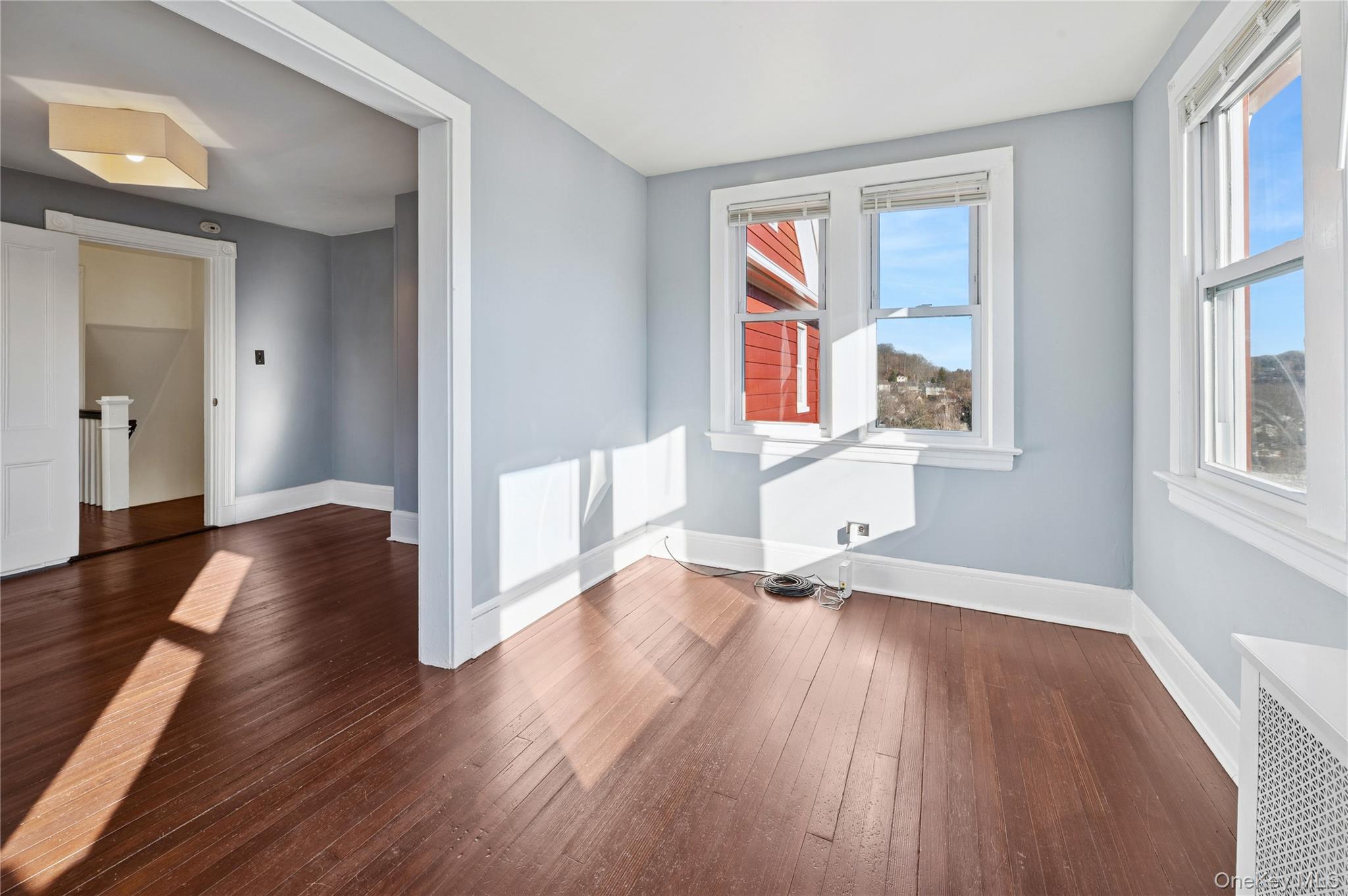 53 Allen Street, Unit 2 Dobbs Ferry, NY 10522 - Photo 23 of 28 Spare room featuring radiator and dark wood finished floors