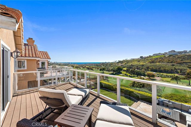 a view of a balcony with table and chairs