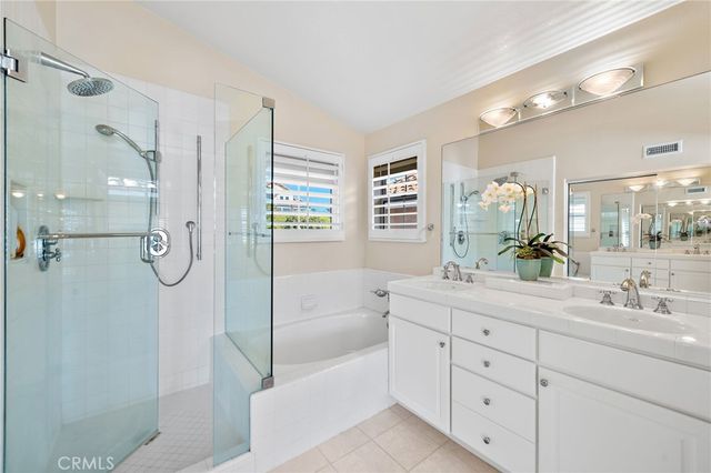 a bathroom with a double vanity sink toilet double vanity and shower