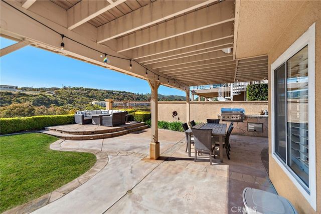 a view of a patio with a table and chairs and potted plants