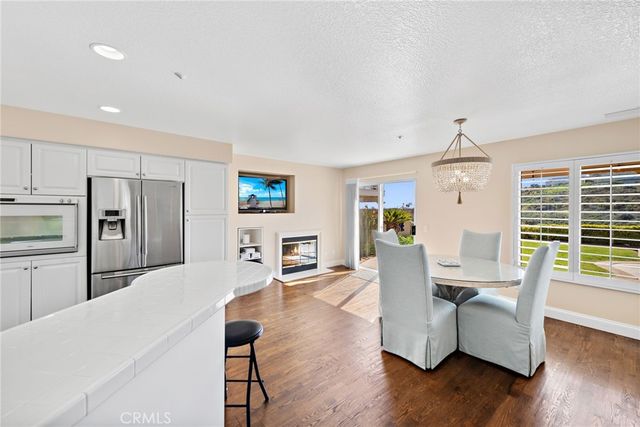 a dining room with furniture and wooden floor