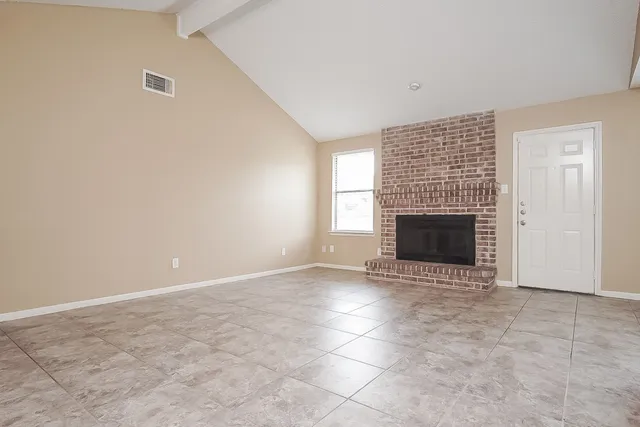 an empty room with a fireplace
