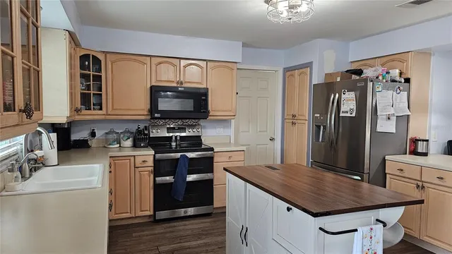 a kitchen with stainless steel appliances a stove microwave and a refrigerator