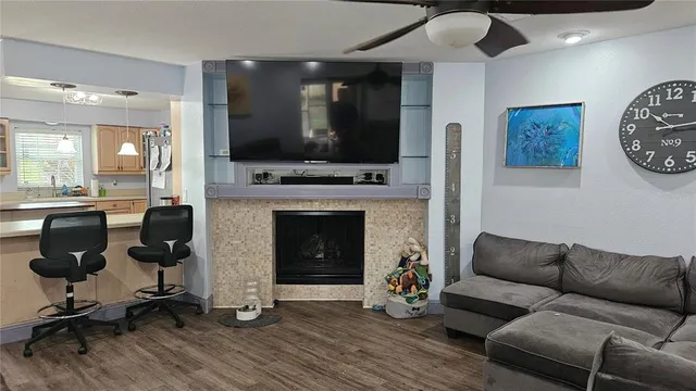 a living room with furniture a flat screen tv and a fireplace