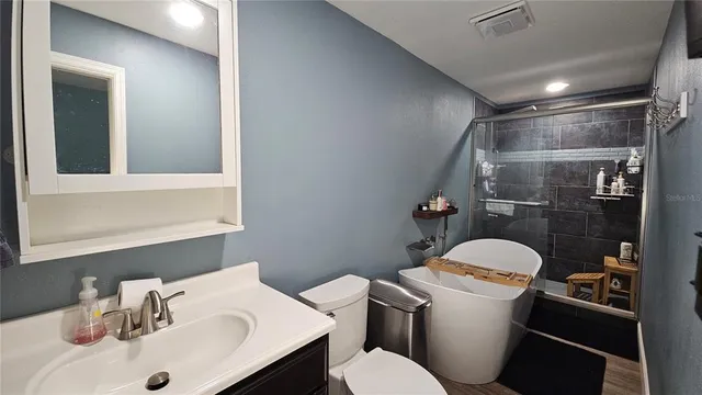a bathroom with a sink mirror vanity and toilet