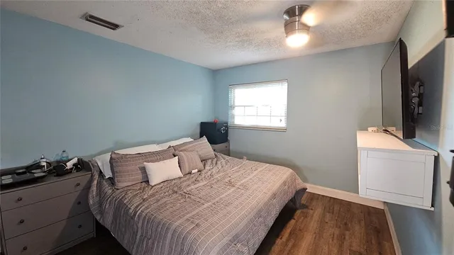 a bedroom with a bed and a flat screen tv