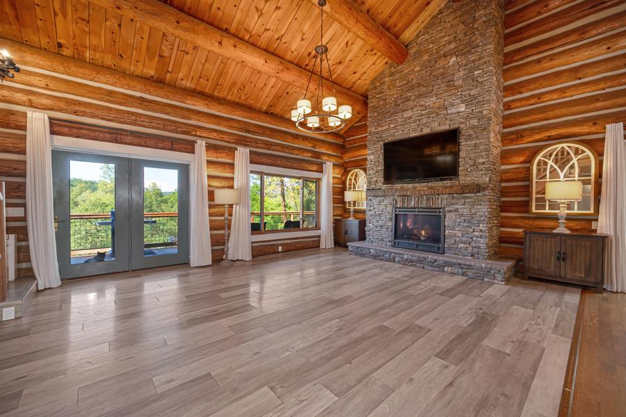 5000 Reservation Road Placerville, CA 95667 - Photo 22 of 85 a view of a livingroom with furniture a flat screen tv and floor to ceiling window