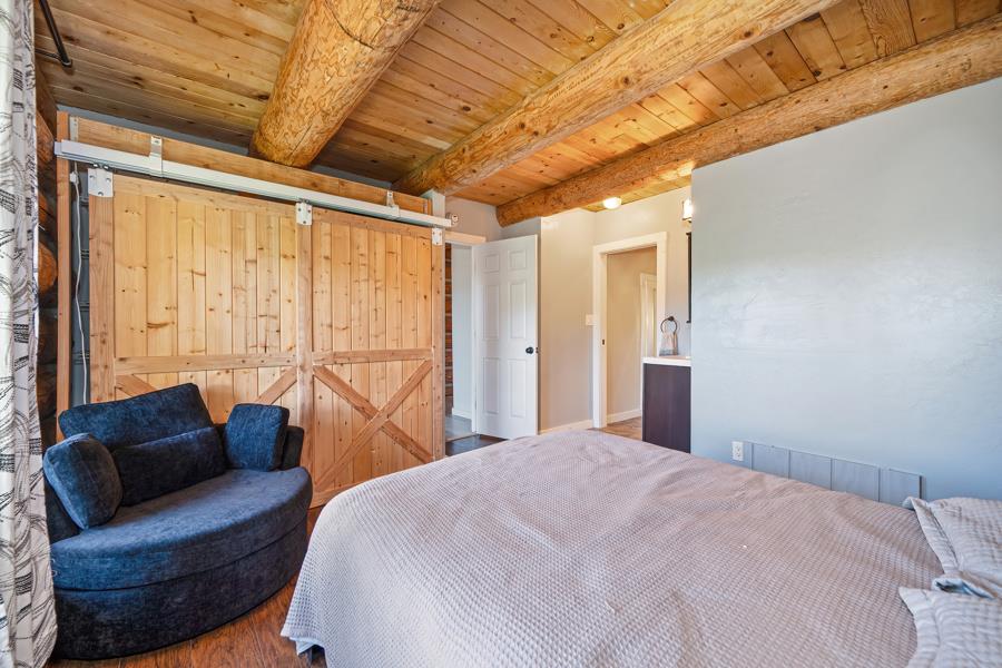 5000 Reservation Road Placerville, CA 95667 - Photo 47 of 85 a bedroom with a large bed couch and a window