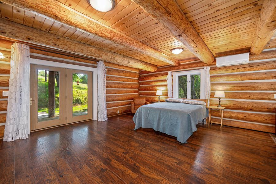 5000 Reservation Road Placerville, CA 95667 - Photo 49 of 85 a spacious bedroom with a bed and wooden floor