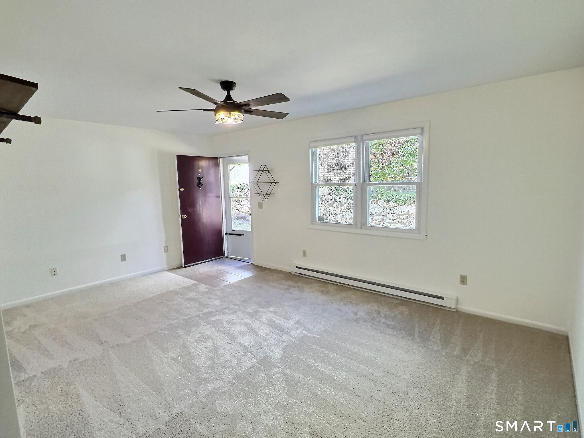 61 Dover Court, Unit B Branford, CT 06405 - Photo 5 of 14 a view of an empty room with a window