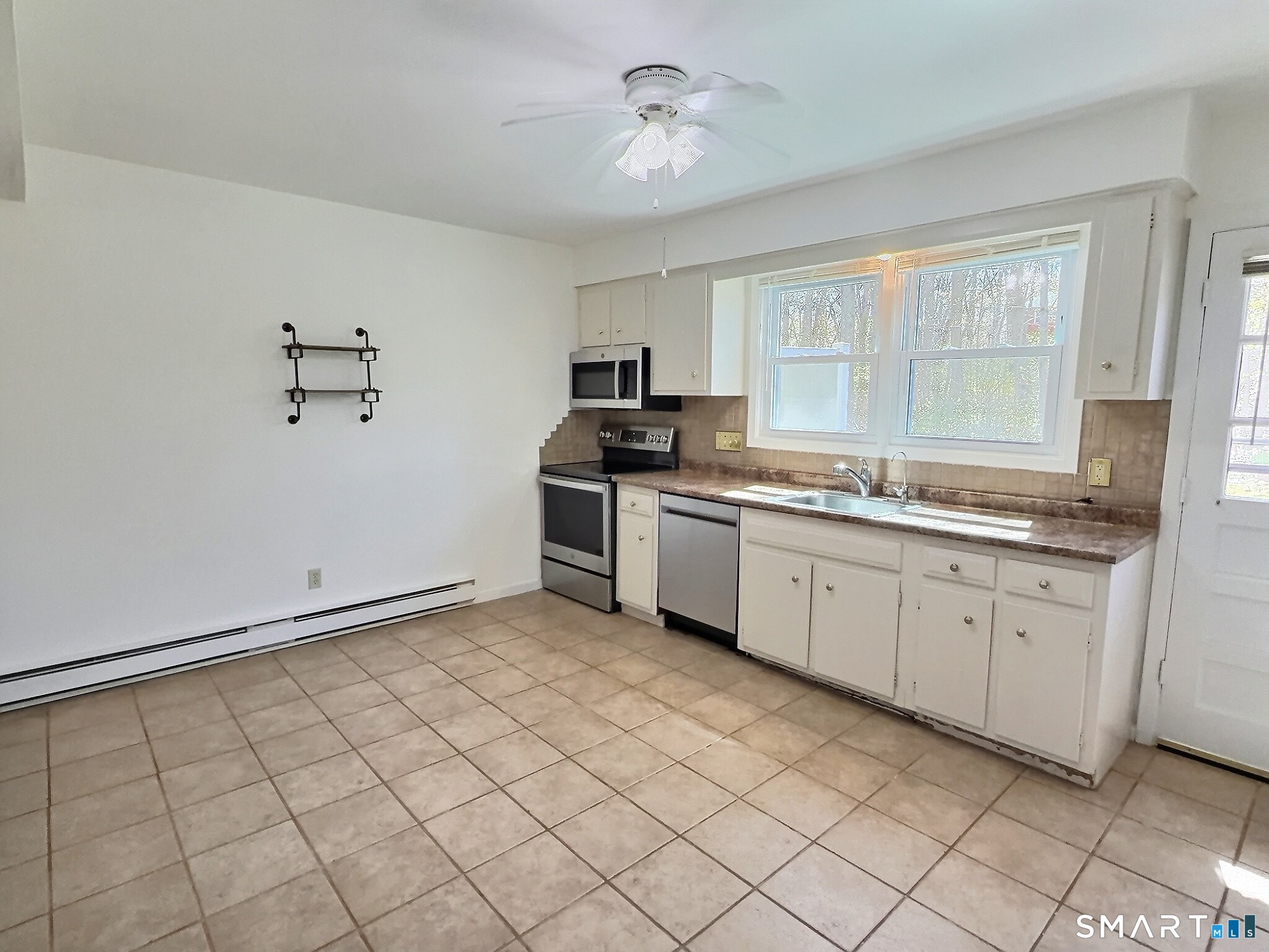 61 Dover Court, Unit B Branford, CT 06405 - Photo 7 of 14 a kitchen with a sink cabinets and window