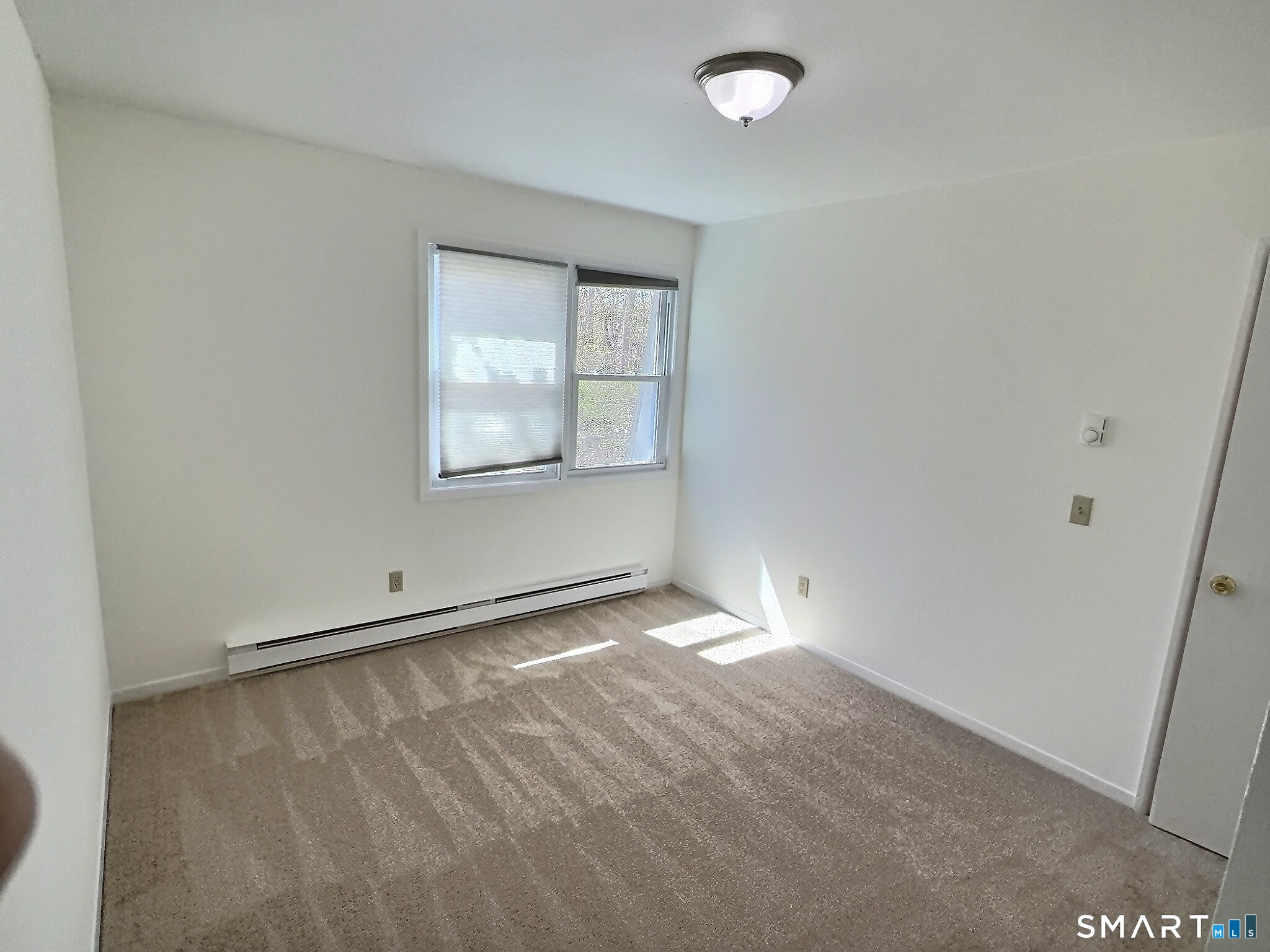 61 Dover Court, Unit B Branford, CT 06405 - Photo 10 of 14 an empty room with a empty space and windows