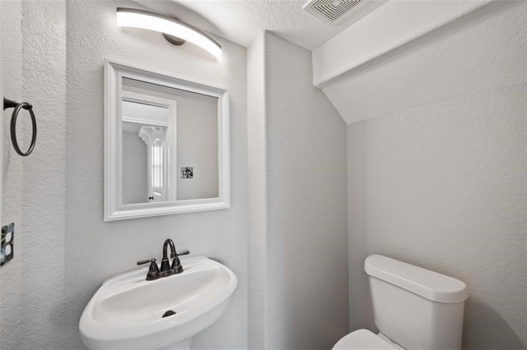 22438 Toronado Ridge Lane Porter, TX 77365 - Photo 10 of 19 Charming powder bathroom featuring modern fixtures and a sleek, compact design perfect for guests.