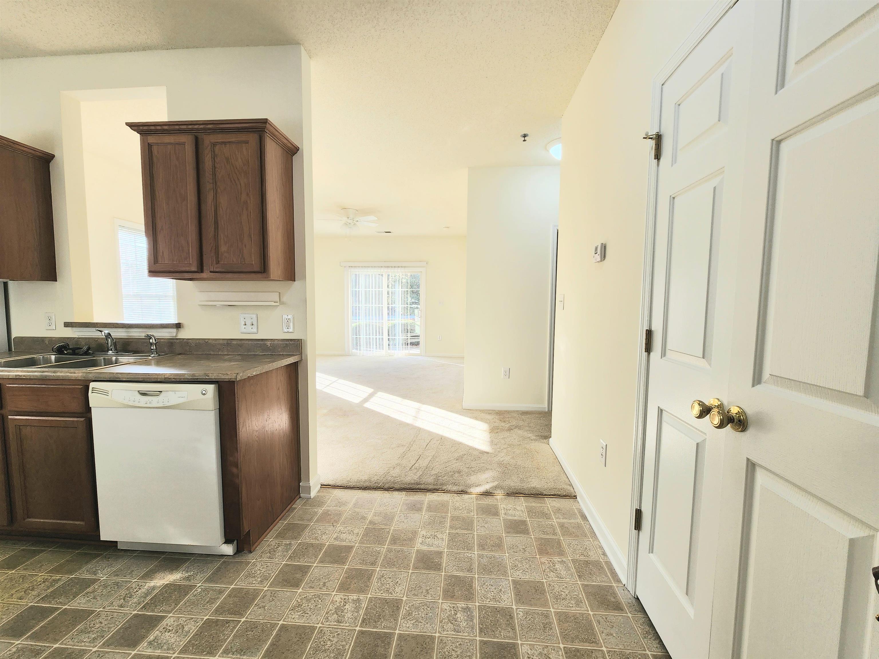 2080 Cross Gate Boulevard, Unit 105 Myrtle Beach, SC 29575 - Photo 12 of 25 Kitchen with dishwasher, dark countertops, a textured ceiling, dark brown cabinetry, and ceiling fan